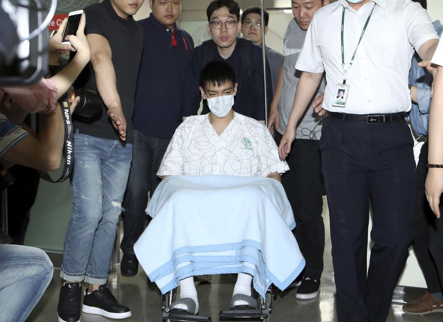 Popular South Korean singer T.O.P. in a wheelchair leaves Ewha Womans University Medical Center in Seoul, South Korea, Friday, June 9, 2017. T.O.P. was released from the hospital after being treated for an overdose of anti-anxiety pills. (Kwon Hyun-koo /Newsis via AP)