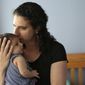 In this Thursday, June 1, 2017 photo Elena Tenenbaum kisses her eight-week-old baby Zoe while standing for a photograph at their home in Providence, R.I. Tenenbaum, a clinical psychology researcher, had her second daughter in April of 2017, and has been able to use Rhode Island&#39;s paid family leave program, which started in 2014 and covers four weeks of partial pay. (AP Photo/Steven Senne)
