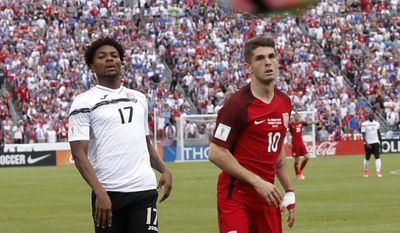 U.S. midfielder Christian Pulisic, right, watches his shot bound out of play, next to Trinidad &amp;amp; Tobago defender Mekell Williams during the first half of a World Cup soccer qualifying match Thursday, June 8, 2017, in Commerce City, Colo. (AP Photo/David Zalubowski)
