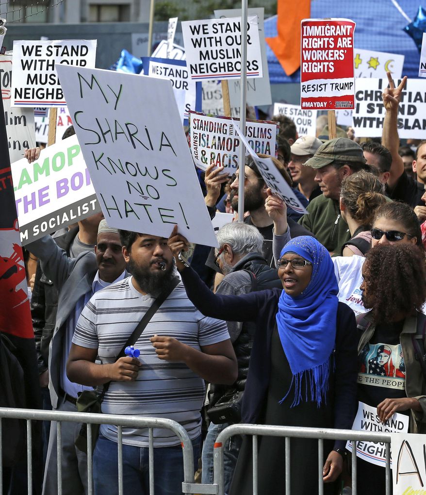 A woman holds a sign that reads &amp;quot;My Sharia Knows No Hate&amp;quot; during a counter-protest to an anti-Islamic law rally Saturday, June 10, 2017, in Seattle.  Rallies against Islamic law have drawn larger counter-rallies in some U.S. cities. Hundreds of counter-protesters marched through Seattle on Saturday to confront a few dozen people claiming Shariah is incompatible with Western freedoms. (AP Photo/Ted S. Warren)