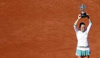 Latvia&#39;s Jelena Ostapenko holds the trophy after winning the women&#39;s final match of the French Open tennis tournament against Romania&#39;s Simona Halep in three sets 4-6, 6-4, 6-3, at the Roland Garros stadium, in Paris, France, Saturday, June 10, 2017. (AP Photo/Petr David Josek)