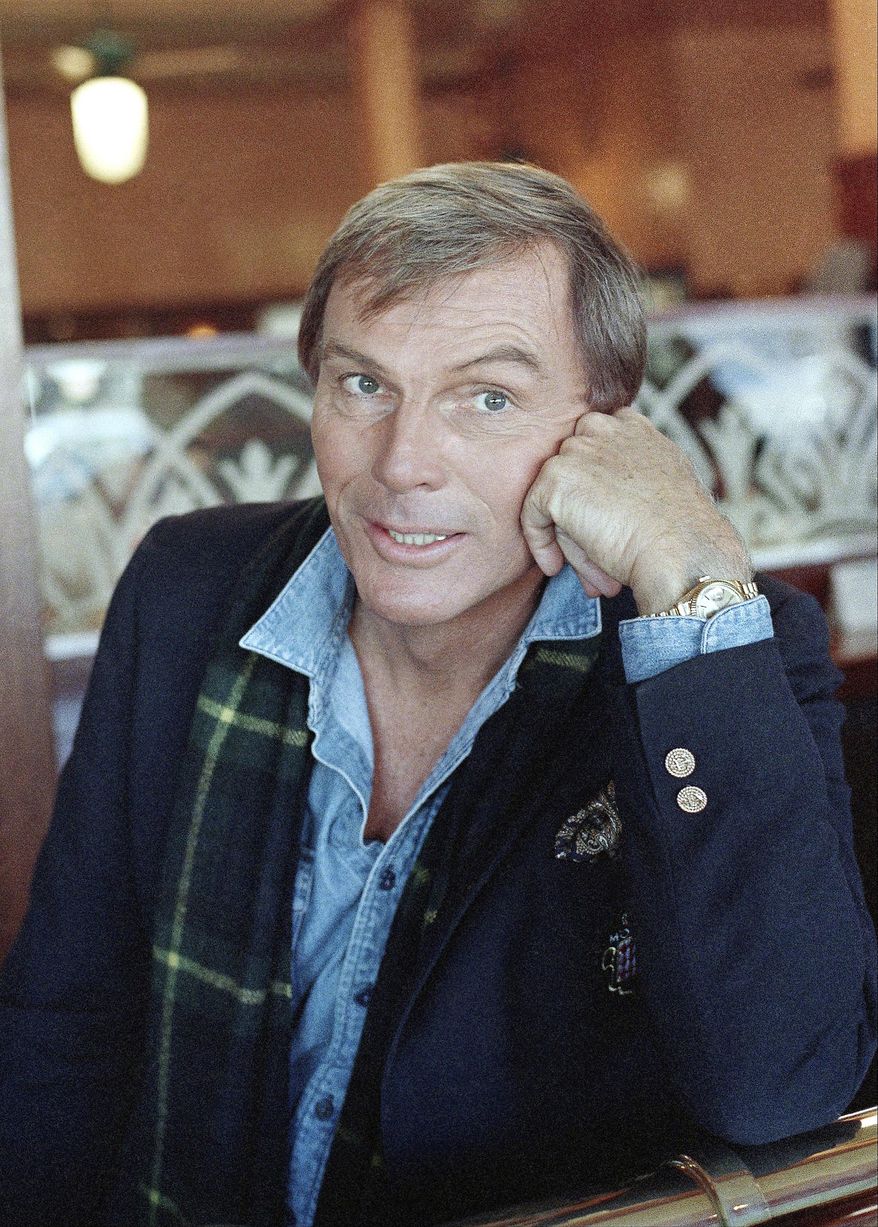 FILE - In this Dec. 11, 1985, file photo, Adam West poses for a photo in Los Angeles. On Saturday, June 10, 2017, his family said the actor, who portrayed Batman in a 1960s TV series, has died at age 88. (AP Photo/Lennox McLendon, File)