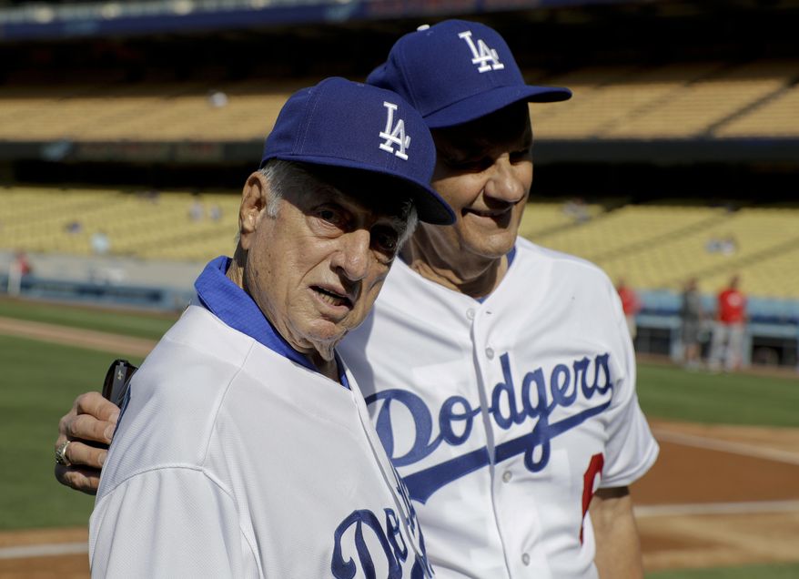 Former Los Angeles Dodger managers Tommy Lasorda, left, and Joe Torre pose for photos before an old-timers baseball game in Los Angeles, Saturday, June 10, 2017. (AP Photo/Chris Carlson)