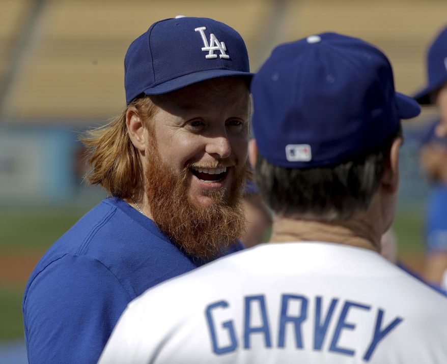 Former Los Angeles Dodger Steve Garvey, right, chats with current third baseman Justin Turner before an old-timers baseball game in Los Angeles, Saturday, June 10, 2017. (AP Photo/Chris Carlson)