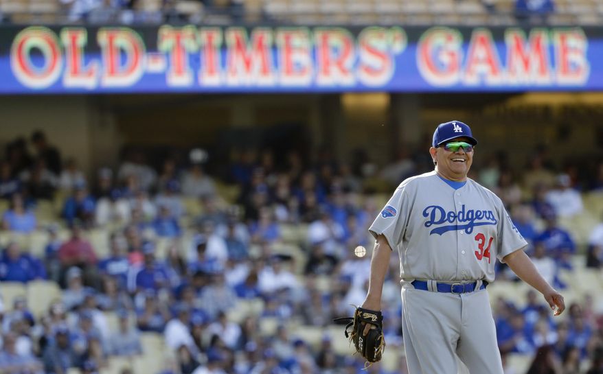 Former Los Angeles Dodgers pitcher Fernando Valenzuela smiles first during the first inning of an old-timers baseball game in Los Angeles, Saturday, June 10, 2017. (AP Photo/Chris Carlson)