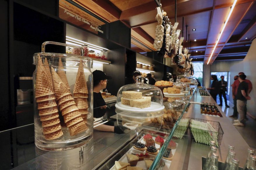 This June 7, 2017 photo shows food items displayed for sale in the Louis section of the lobby at the PUBLIC hotel, in New York. The new hotel on Manhattan's Lower East Side is the latest project from Ian Schrager, who's known for introducing the concept of boutique hotels. (AP Photo/Richard Drew)
