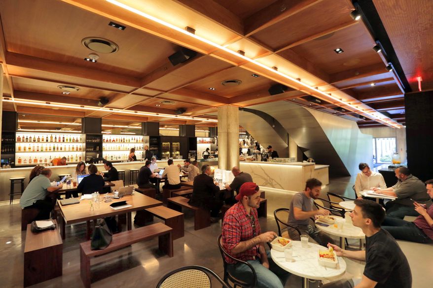 In this June 1, 2017 photo, people dine in the Louis space in the lobby of the PUBLIC hotel, in New York. (AP Photo/Richard Drew)