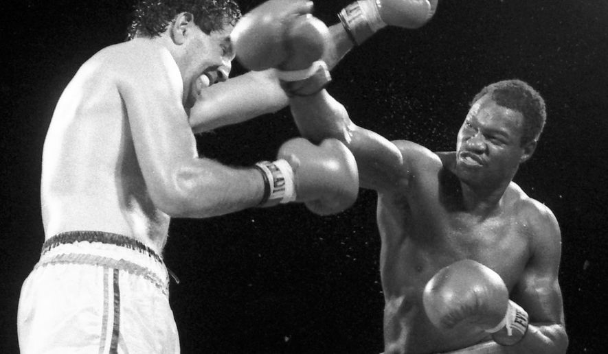 World Boxing Council champion Larry Holmes, right, delivers a flurry of blows to challenger Gerry Cooney during the 13th and final round of their championship fight,  June, 12, 1982 at Caesars Palace in Las Vegas. Holmes won the fight and retained his crown with a 13th round knockout. It was 25 years ago on a blisteringly hot night in Las Vegas, and Holmes was defending his heavyweight title against the big-punching Cooney in the richest fight of its time.  (AP Photo/file)