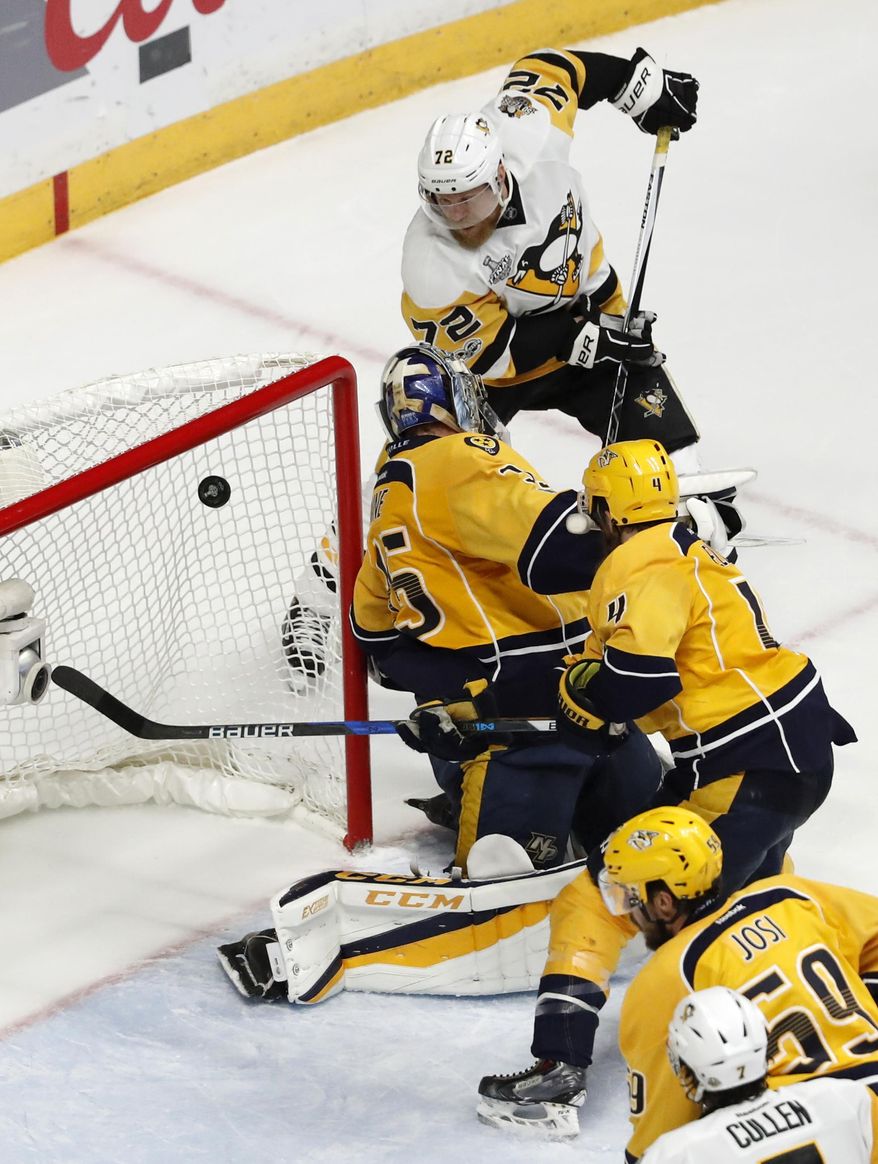 Pittsburgh Penguins&#x27; Patric Hornqvist (72), of Sweden, scores a goal against Nashville Predators goalie Pekka Rinne, of Finland, during the third period of Game 6 of the NHL hockey Stanley Cup Final, Sunday, June 11, 2017, in Nashville, Tenn. (AP Photo/Jeff Roberson)