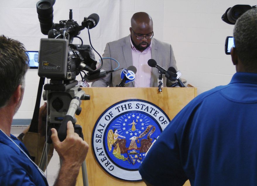 FILE - In this April 24, 2017, file photo, Arkansas prison department spokesman Solomon Graves speaks to reporters amid a series of executions at the Cummins Unit prison at Varner, Arkansas. Additional arguments over whether the state's three-drug execution protocol are expected if the state sets more execution dates or when a federal judge resumes a hearing on a claim by surviving inmates that they're at a risk for cruel or unusual punishment. (AP Photo/Kelly P. Kissel, File)