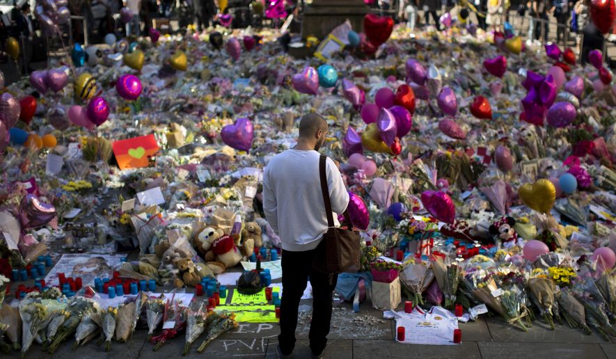 FILE- In this Friday, May 26 2017 file photo, a man stands next to flowers for the victims of Monday&#39;s bombing at St Ann&#39;s Square in central Manchester, England, Friday, May 26 2017. British police say everyone arrested over the Manchester concert bombing has been released without charge, but detectives are still not sure whether the attacker had accomplices. (AP Photo/Emilio Morenatti, File)