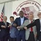 International Boxing Hall of Fame Class of 2017 inductees, from left, Steve Farhood, Barry Tompkins, Marco Antonio Barrera, Evander Holyfield, Jerry Roth and Johnny Lewis display their rings following the induction ceremony in Canastota, N.Y., Sunday, June 11, 2017. (Kyle Mennig/Oneida Daily Dispatch via AP)