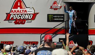 Darrell Wallace Jr. waves to the crowd as he is introduced before the NASCAR Cup Series Pocono 400 auto race, Sunday, June 11, 2017, in Long Pond, Pa. (AP Photo/Matt Slocum)