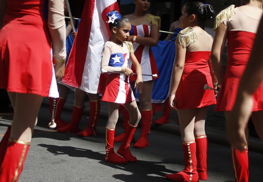 A marching band prepares to participate in the Puerto Rican Day Parade in New York, Sunday, June 11, 2017. (AP Photo/Seth Wenig)
