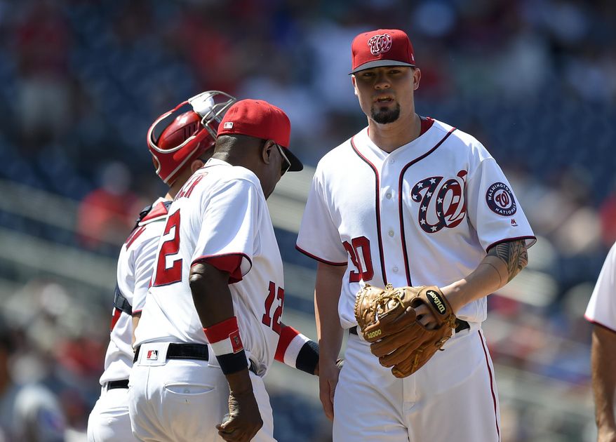 Washington Nationals relief pitcher Koda Glover, right, is pulled from a baseball game by Dusty Baker, left, during the ninth inning against the Texas Rangers, Saturday, June 10, 2017, in Washington. (AP Photo/Nick Wass)