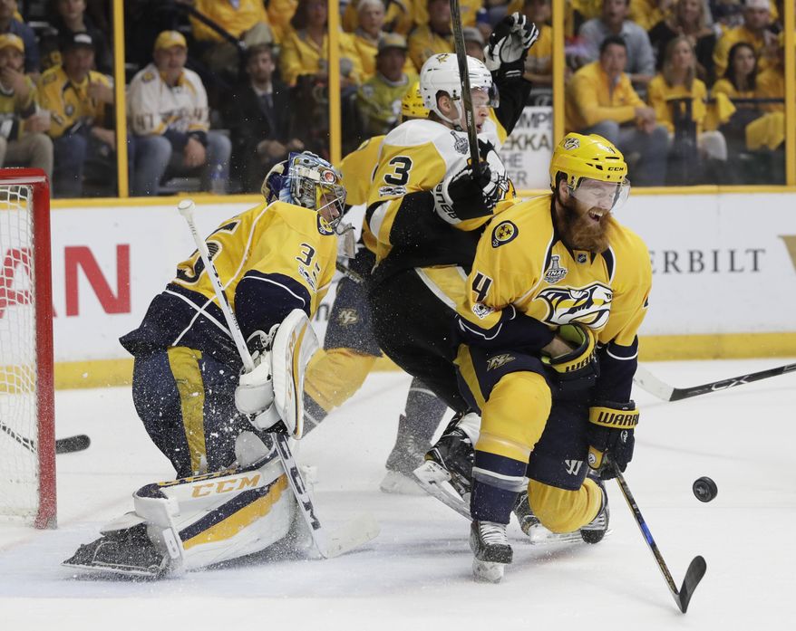 Nashville Predators&#x27; Ryan Ellis (4) and goalie Pekka Rinne (35), of Finland, defend the goal against Pittsburgh Penguins&#x27; Olli Maatta (3), of Finland, during the second period of Game 6 of the NHL hockey Stanley Cup Final, Sunday, June 11, 2017, in Nashville, Tenn. (AP Photo/Mark Humphrey)