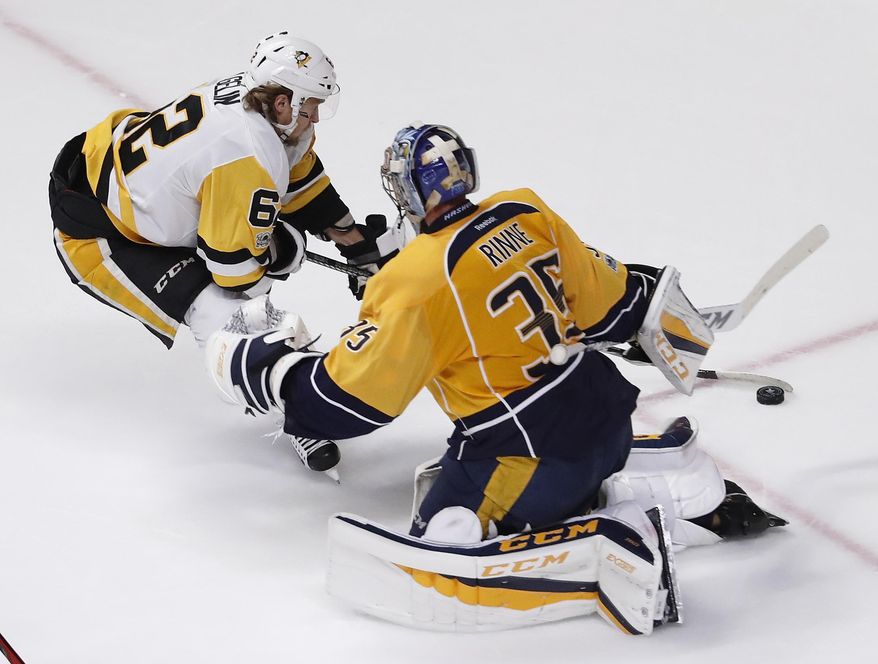 Pittsburgh Penguins&#x27; Carl Hagelin (62), of Sweden, tries to score against Nashville Predators goalie Pekka Rinne (35), of Finland, during the second period of Game 6 of the NHL hockey Stanley Cup Final, Sunday, June 11, 2017, in Nashville, Tenn. (AP Photo/Jeff Roberson)