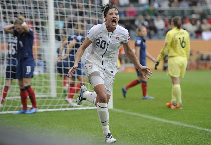 FILE - In this July 13, 2011, file photo, United States' Abby Wambach celebrates scoring her side's second goal during a semifinal match against France at the Women's Soccer World Cup in Moenchengladbach, Germany. Wambach is astonished when she reflects on the year she's had. She went from admitting a problem with alcohol and prescription pills to getting sober and marrying a "Christian mommy blogger." The biggest stunner? She doesn't miss soccer a bit.(AP Photo/Martin Meissner, File)