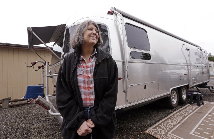 In this photo taken Thursday, June 8, 2017, Nancy Zingheim stands in front of an Airstream trailer, similar to one owned by former RV park tenant Rita Poe, in Chimacum, Wash. Zingheim barely knew Poe when Poe approached her office at the RV park in Washington state, asking for help with her will. Weeks later, the 66-year-old Poe died of colorectal cancer, leaving nearly $800,000 to a dozen national wildlife refuges and parks, mostly in the West. She named Zingheim the executor. (AP Photo/Elaine Thompson)
