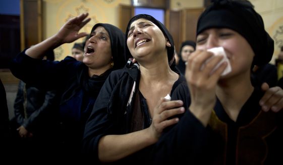 Coptic Christians grieve for the 29 Copts killed in an Islamic State ambush of their bus on a trip to volunteer at a monastery. (Associated Press/File)