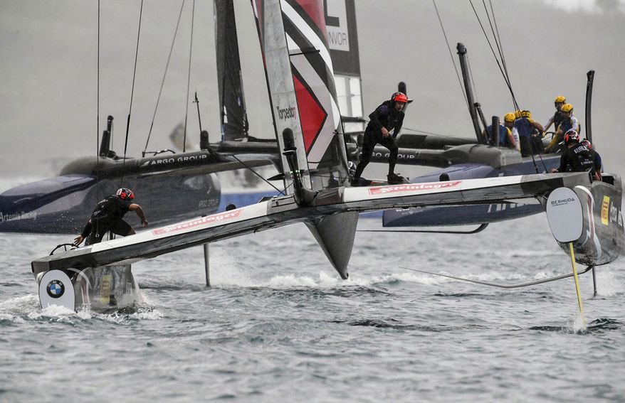 In this photo provided by the America's Cup Event Authority, Emirates Team New Zealand, foreground, competes against Sweden's Artemis Racing on the third day of the best-of-nine America's Cup challenger finals on Bermuda's Great Sound, Monday, June 12, 2017. (Ricardo Pinto/America's Cup Event Authority via AP)