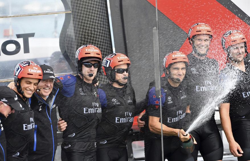In this photo provided by the America's Cup Event Authority, Emirates Team New Zealand celebrates after defeating Sweden's Artemis Racing on the third day of the best-of-nine America's Cup challenger finals on Bermuda's Great Sound, Monday, June 12, 2017. (Ricardo Pinto/America's Cup Event Authority via AP)
