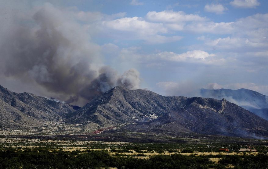 This June 9, 2017, photo shows the Lizard Fire burning in the Dragoon Mountains as seen from Johnson Road south of Interstate 10 in Southeastern Ariz. (Mike Christy/Arizona Daily Star via AP)