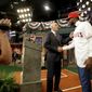 Jordon Adell, right, an outfielder and pitcher from Ballard High School in Louisville, Ky., shakes hands with commissioner Rob Manfred after being selected No. 10 by the Los Angeles Angels in the first round of the Major League Baseball draft, Monday, June 12, 2017, in Secaucus, N.J. (AP Photo/Julio Cortez)