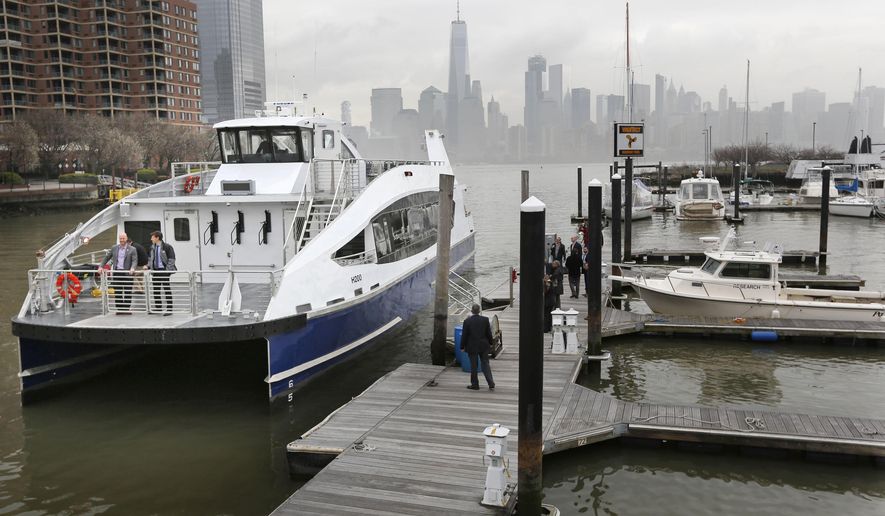 FILE - In this April 5, 2017 file photo, a newly built ferry, to be used around the five boroughs of New York City, comes in to dock in Jersey City, N.J. While the New York region’s tunnels, bridges and railways burst at the seams, ferries may be the answer for commuters sick of clogged roads and an unreliable rail system. For now, price is a barrier. New York Waterway could accommodate thousands more commuters from New Jersey. But it doesn’t receive state or federal subsidies and so has to charge more than buses or trains. (AP Photo/Seth Wenig, File)