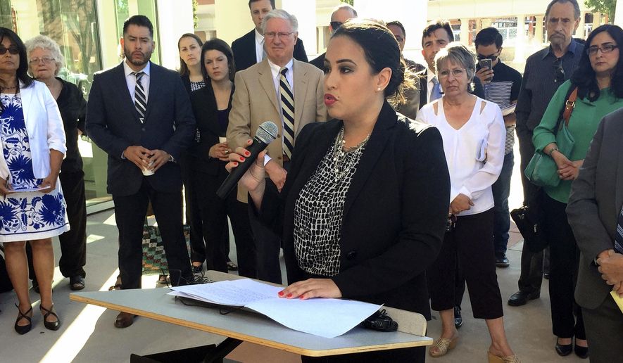 Marisa Bono, southwest regional counsel for the Mexican American Legal Defense and Educational Fund, outlines accusations that the state of New Mexico has failed to provide essential educational opportunities to all students, outside a state district courthouse in Santa Fe, N.M., Monday, June 12, 2017. Parents, school districts and advocacy groups allege that New Mexico's education system isn't meeting its responsibilities for Native American students, low-income students and those learning English as a second language. (AP Photo/Morgan Lee)