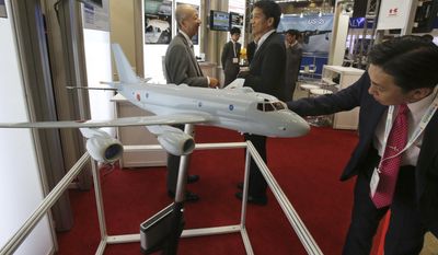 A visitor looks at a miniature model of P-1 Maritime Patrol Aircraft of Kawasaki Heavy Industries, during &amp;quot; MAST Asia&amp;quot;,  Japan&#39;s international arms exhibit, in Chiba, near Tokyo, Monday, June 12, 2017. The three-day exhibit, second since Japan’s 2014 easing of arms export rules, began Monday near Tokyo.(AP Photo/Koji Sasahara)