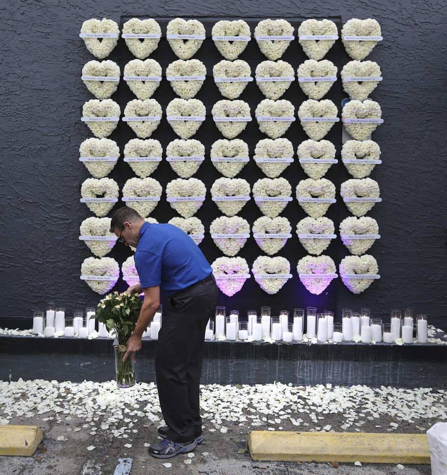 Wreaths representing each of the victims of the Pulse nightclub shooting are displayed at the Pulse nightclub memorial site in Orlando, Fla., Monday, June 12, 2017. A gunman opened fire at the nightclub one year ago in the worst mass shooting in modern U.S. history, killing 49 people. (Joe Burbank/Orlando Sentinel via AP)