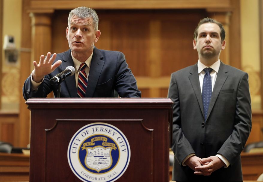 Jersey City Public Safety Director James Shea, left, and Mayor Steven Fulop take questions from journalists during a news conference in Jersey City, N.J., Monday, June 12, 2017. The officials announced some suspensions after video showed police kicking a man and dragging him into a roadway after a fiery crash. (AP Photo/Seth Wenig)