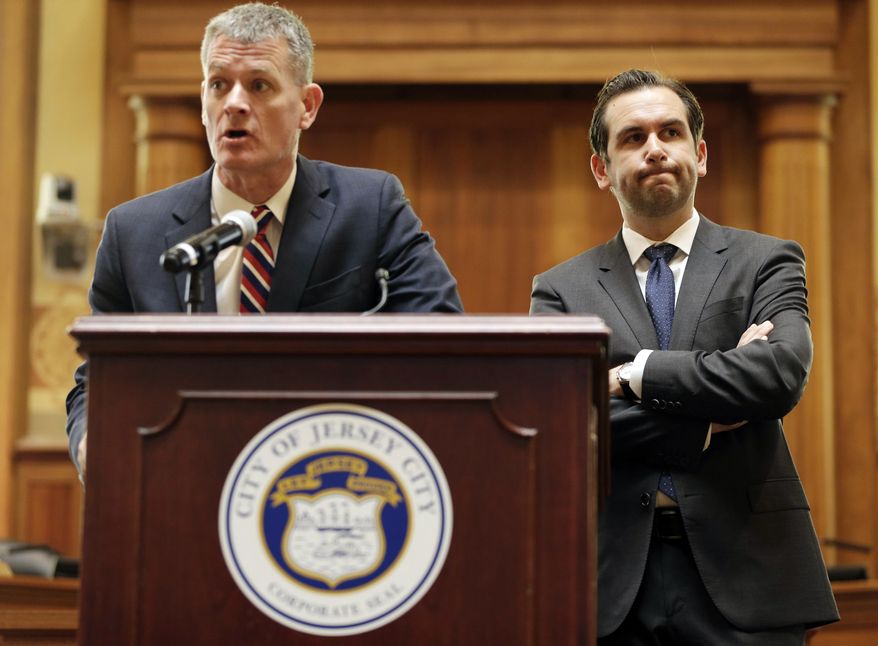 Jersey City Public Safety Director James Shea, left, and Mayor Steven Fulop take questions from journalists during a news conference in Jersey City, N.J., Monday, June 12, 2017. The officials announced some suspensions after video showed police kicking a man and dragging him into a roadway after a fiery crash. (AP Photo/Seth Wenig)