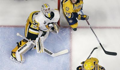 Pittsburgh Penguins goalie Matt Murray (30), and Nashville Predators&#39; Viktor Arvidsson (38), of Sweden, the puck in the air during the third period of Game 6 of the NHL hockey Stanley Cup Final, Sunday, June 11, 2017, in Nashville, Tenn. (AP Photo/Mark Humphrey)