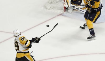 Pittsburgh Penguins&#39; Jake Guentzel (59) shoots as Nashville Predators goalie Pekka Rinne (35), of Finland, defends the goal during the first period of Game 6 of the NHL hockey Stanley Cup Final, Sunday, June 11, 2017, in Nashville, Tenn. (AP Photo/Jeff Roberson)