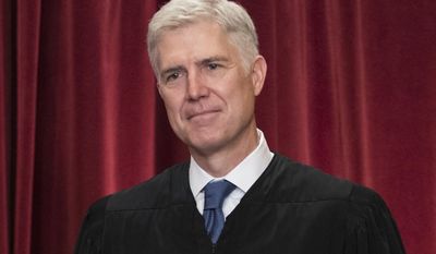 FILE - In this June 1, 2017 file photo Supreme Court Associate Justice Neil Gorsuch is seen during an official group portrait at the Supreme Court Building Washington. Gorsuch’s first Supreme Court opinion Monday, June 12, 2017, stayed true to what Gorsuch promised in his nomination hearing and to the reputation for good writing he developed as an appellate judge. (AP Photo/J. Scott Applewhite, File)