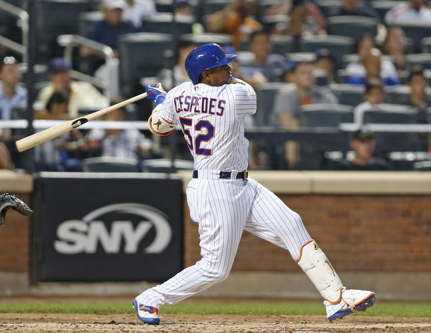 Yoenis Cespedes swings during a baseball game against the Chicago Cubs, Monday, June 12, 2017, in New York. The Mets won 6-1. Cespedes exited because of a sore left heel, two days after he returned from a six-week stint on the disabled list. (AP Photo/Kathy Willens)