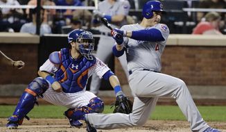 Chicago Cubs&#39; Anthony Rizzo (44) follows through on an hits an RBI double as New York Mets catcher Travis d&#39;Arnaud watches during the third inning of a baseball game Tuesday, June 13, 2017, in New York. (AP Photo/Frank Franklin II)