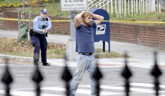 In this Dec. 4, 2016, file photo, Edgar Maddison Welch, of Salisbury, N.C., surrenders to police in Washington. A man who walked into a pizza restaurant in the District of Columbia with an assault rifle, intending to investigate internet rumors dubbed “pizzagate,” is apologizing and saying he realizes now “just how foolish and reckless” he was. Welch made those statements in a letter submitted to a judge Tuesday, June 13, 2017, ahead of his sentencing. (Sathi Soma via AP, File)