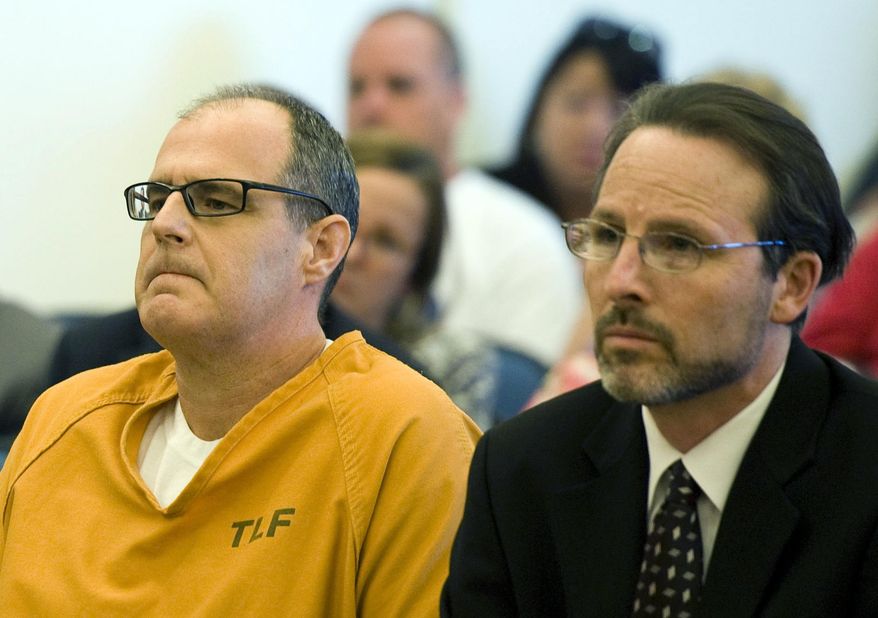 FILE - This May 2, 2014 file photo shows Scott Dekraai, left, sitting with his public defender Scott Sanders in Orange County Superior Court in Santa Ana, Calif., waiting for a ruling over over allegations of prosecutorial misconduct and misuse of jailhouse informants. A grand jury will release findings Tuesday, June 13, 2017, from an investigation into the use of jailhouse informants in Orange County amid a long-running scandal over the use of the snitches. (Kevin Sullivan/The Orange County Register via AP, File)