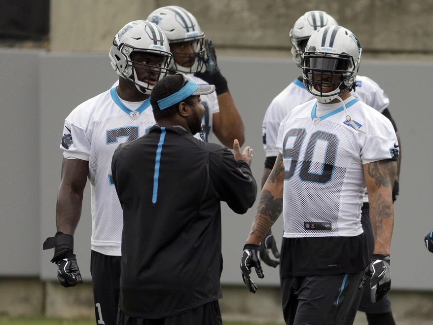 Carolina Panthers defensive end Julius Peppers (90) listens to assistant defensive line coach Sam Mills III during the NFL football team's minicamp in Charlotte, N.C., Tuesday, June 13, 2017. (AP Photo/Chuck Burton)