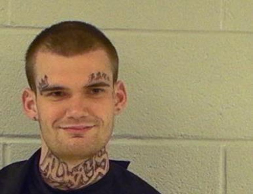 This photo provided by the Elbert County Sheriff's Office taken on Oct. 13, 2015 shows inmate Ricky Dubose. Dubose and Donnie Russell Rowe escaped after killing two prison guards during a bus transport in Georgia. Both are being sought by law enforcement. Authorities in Georgia have released another photo of Dubose, showing prominent tattoos. (Elbert County Sheriff's Office via AP)