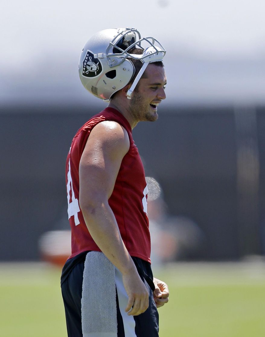 Oakland Raiders quarterback Derek Carr laughs during a break in NFL football practice on Tuesday, June 13, 2017, at the team&#x27;s training facility in Alameda, Calif. (AP Photo/Ben Margot)