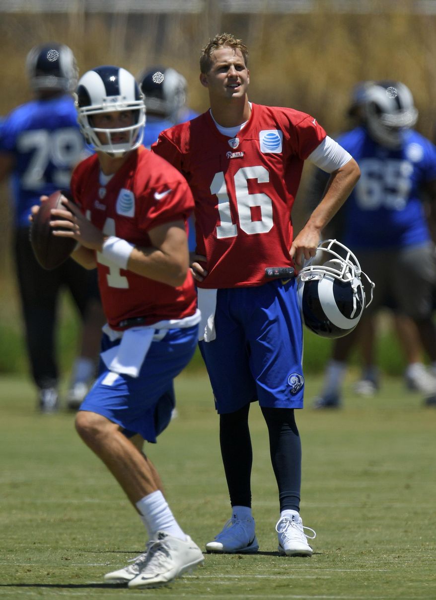 Los Angeles Rams quarterback Jared Goff, right, watches quarterback Sean Mannion pass during NFL football practice, Tuesday, June 13, 2017, in Thousand Oaks, Calif. (AP Photo/Mark J. Terrill)