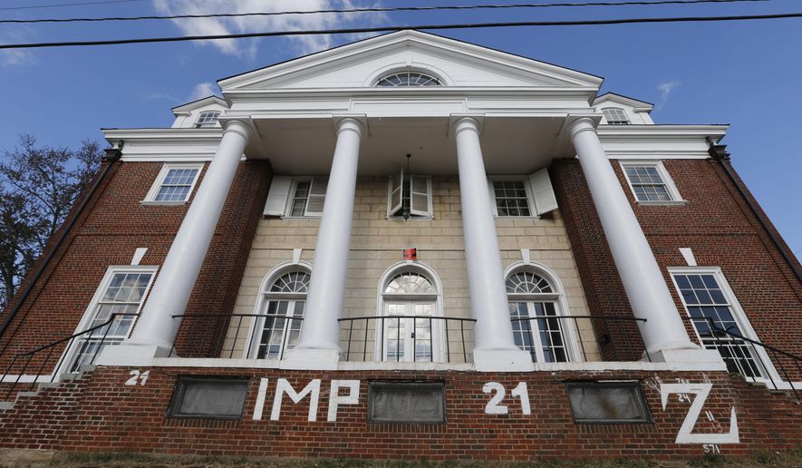 FILE - This Nov. 24, 2014, file photo, shows the Phi Kappa Psi house at the University of Virginia in Charlottesville, Va. Rolling Stone agreed to pay $1.65 million to settle a defamation lawsuit filed by the University of Virginia fraternity over a debunked story about a rape on campus, the fraternity said Tuesday, June 13, 2017. (AP Photo/Steve Helber, File)