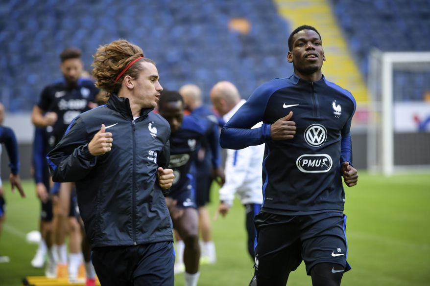 France's national soccer team players Antoine Griezmann, left, and Paul Pogba in action during a training session on the eve of the their World Cup qualification soccer match against Sweden at Friends Arena in Stockholm, Thursday June 8, 2017. (Henrik Montgomery/TT via AP)
