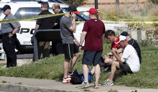 People gather near the scene of a shooting near a baseball field in Alexandria, Va., Wednesday, June 14, 2017, where House Majority Whip Steve Scalise of La. was shot during a congressional baseball practice. (AP Photo/Alex Brandon)