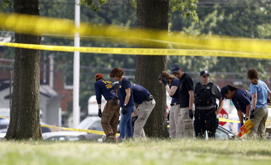 Investigators look for evidence around the baseball field in Alexandria, Va., Wednesday, June 14, 2017, that was the scene of a shooting where House Majority Whip Steve Scalise of La., and others, were shot during a congressional baseball practice. (AP Photo/Alex Brandon)