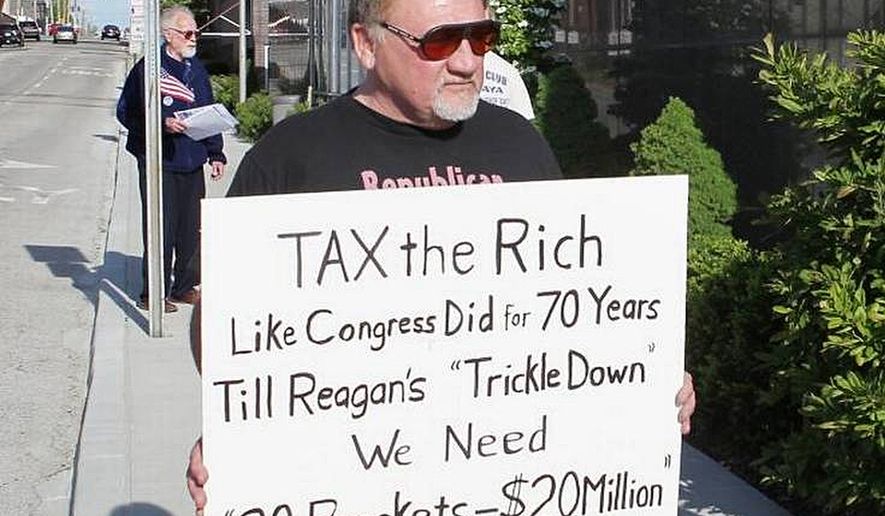 In this undated file photo, James Hodgkinson holds a sign during a protest outside of a United States Post Office in Belleville, Ill. Hodgkinson has been identified as the suspect in the Wednesday, June 14, 2017, Washington D.C. shooting. (Derik Holtmann/Belleville News-Democrat via AP)